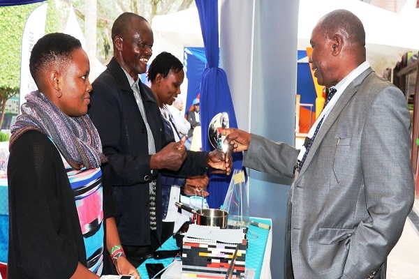 Dr. Pius Mutisya, OGW, Chair of the board interacting with innovations in the CEMASTEA booth  during the 2nd Multi-Sectoral Conference on Science, Technology and innovations (MS-COSTI 2) held at Safari Park Hotel May, 2023
