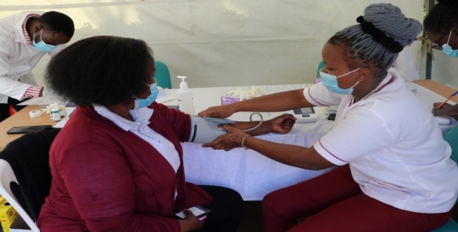 A CEMASTEA member of staff having vitals checked during a medical camp