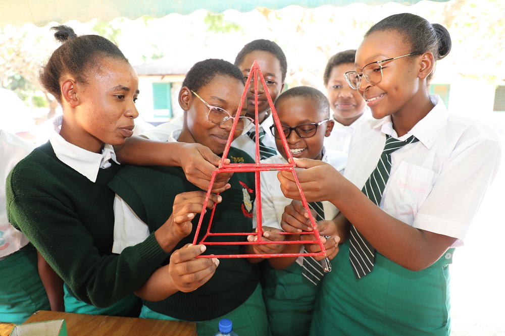 Mulango Girls High School students study a teaching and learning aid for Mathematics at a Mathematics booth at the school set up by CEMASTEA to mark this year`s International Day for Women and Girls in Science.