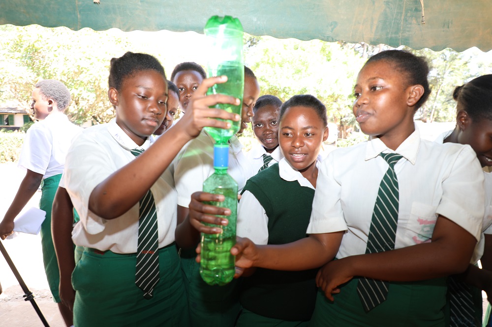 Mulango Girls High school students in Kitui County experiment a concept in physics during a STEM mentorship program organized by CEMASTEA